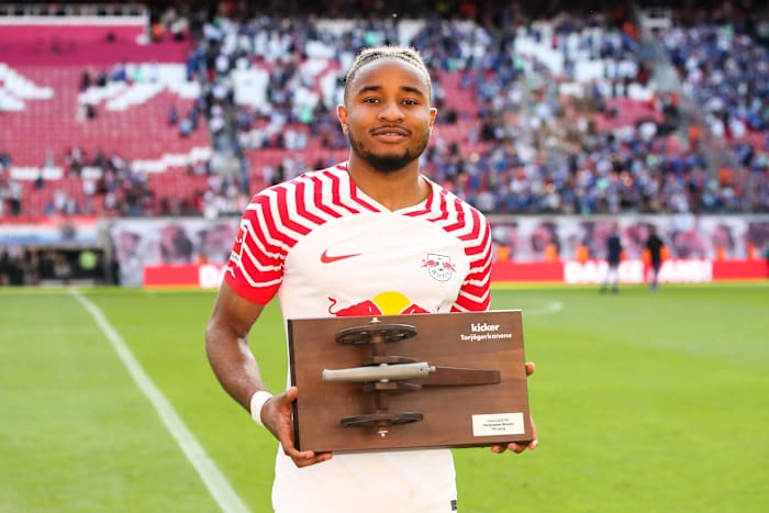 RB Leipzig striker Christopher Nkunku pictured holding his trophy after ending the 2022/23 Bundesliga season as the joint top scorer